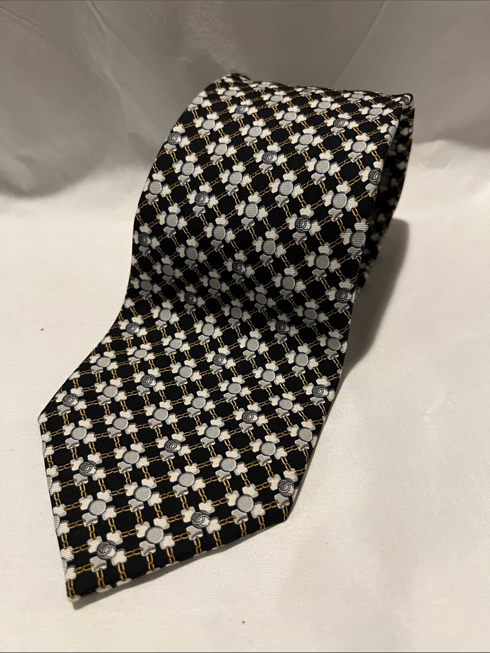 CHANEL Black Tie with White Floral Grid and Gold Chain Pattern